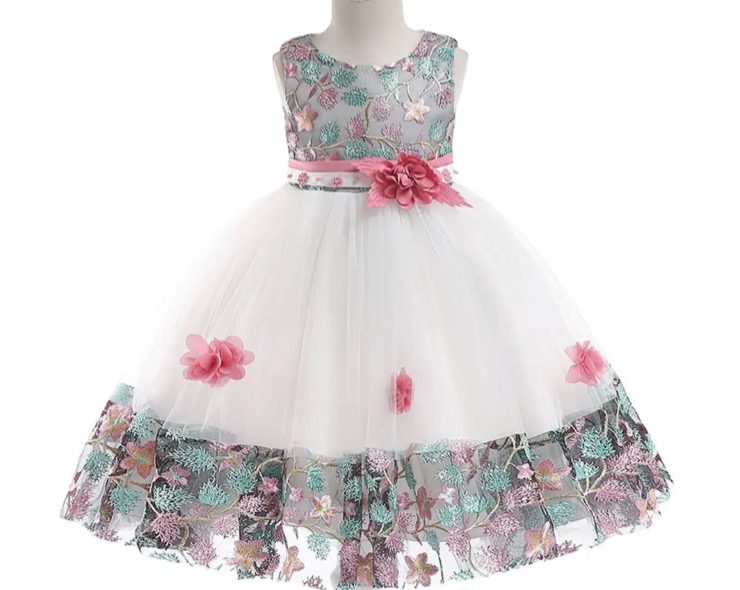 Elegant white dress with floral patterns and pink accents for girls.