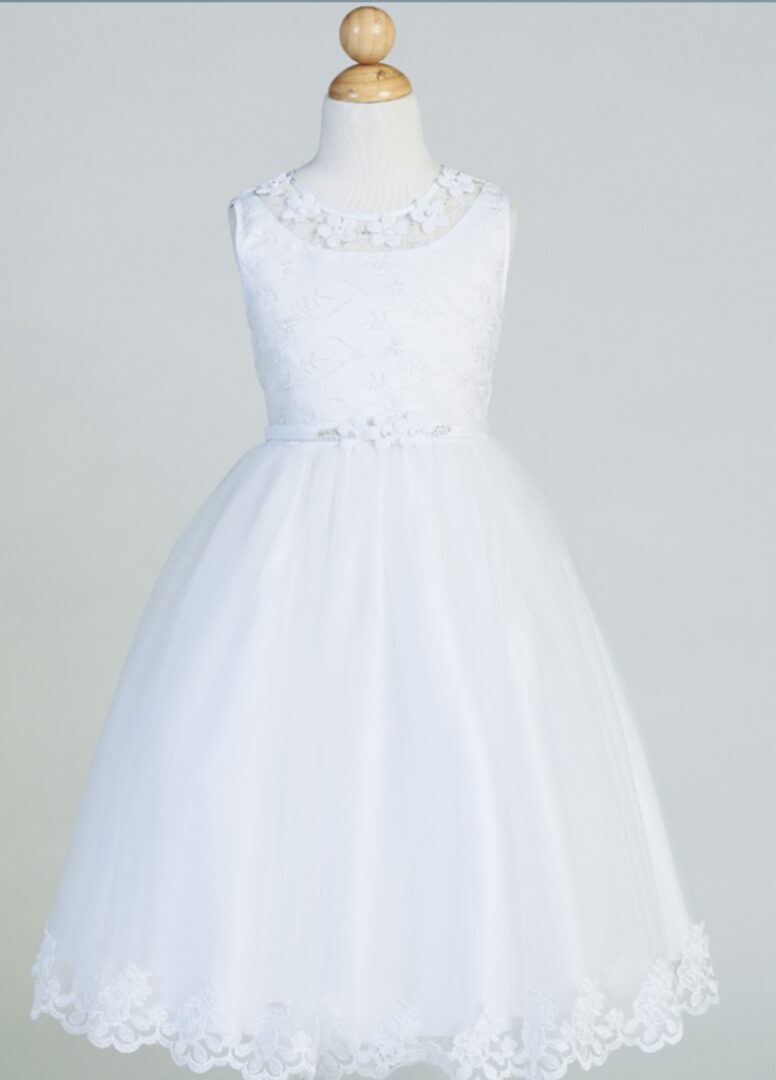 A white color frock with floral lace on neck and bottom