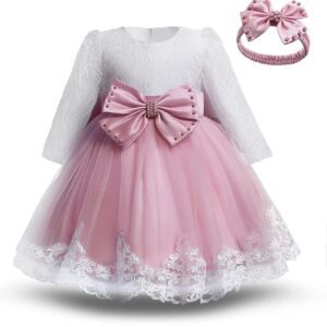 A pink dress with a bow and long sleeves.