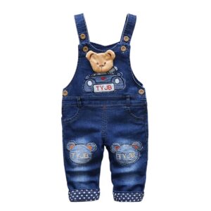 A pair of overalls with a teddy bear on them.