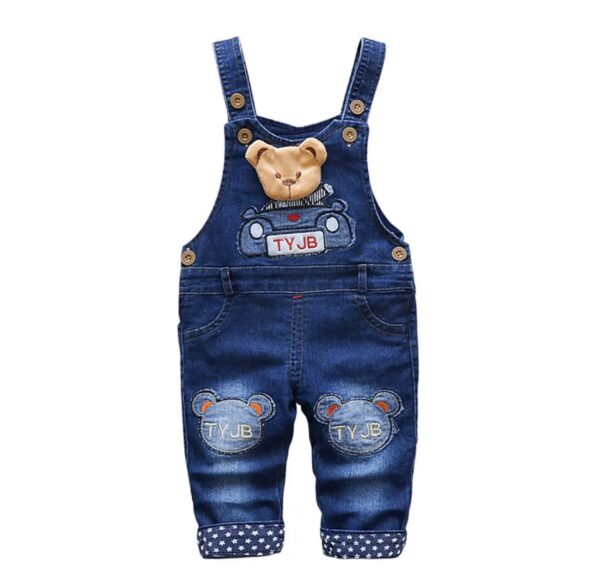 A pair of overalls with a teddy bear on them.